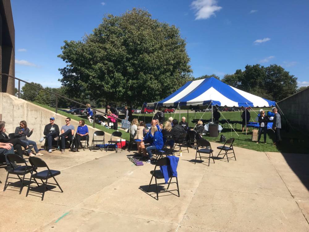 GVSU volleyball alumni, friends, and family outside at a tailgate
